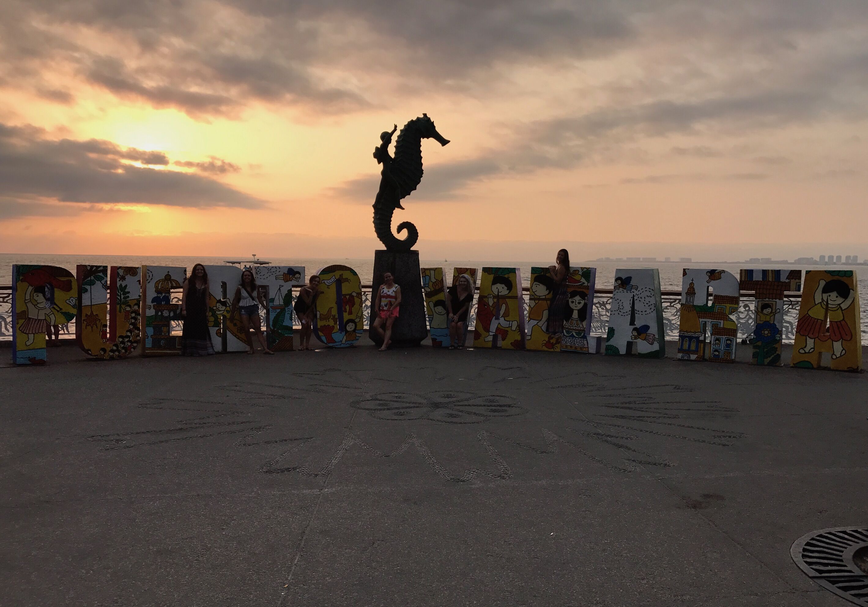 Puerto Vallarta sign with a seahorse on top with a beach background