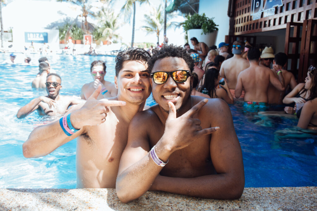 two men smiling near pool