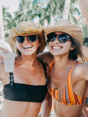 two ladies smiling in hats